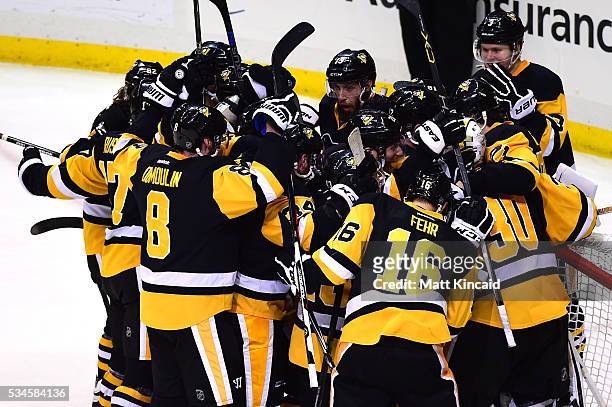 The Pittsburgh Penguins celebrate after defeating the Tampa Bay Lightning in Game Seven of the Eastern Conference Final with a score of 2 to 1 during...