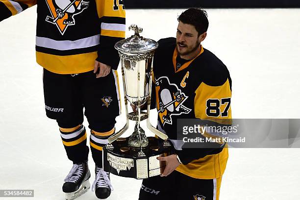 Sidney Crosby of the Pittsburgh Penguins celebrate by holding the Prince of Wales Trophy after defeating the Tampa Bay Lightning in Game Seven of the...