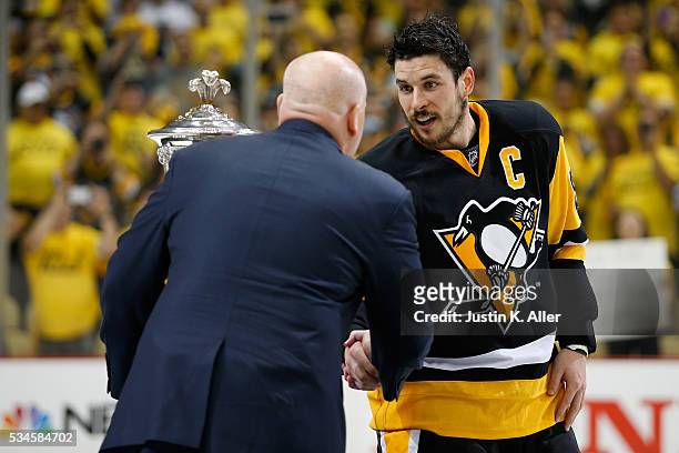 Deputy Commissioner Bill Daly presents Sidney Crosby of the Pittsburgh Penguins with the Prince of Wales Trophy after defeating the Tampa Bay...
