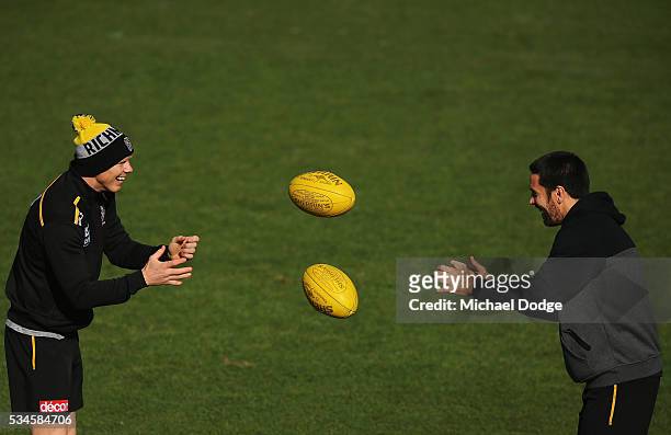 Jack Riewoldt and Troy Chaplin handball to eachother during a Richmond Tigers AFL training session at ME Bank Centre on May 27, 2016 in Melbourne,...