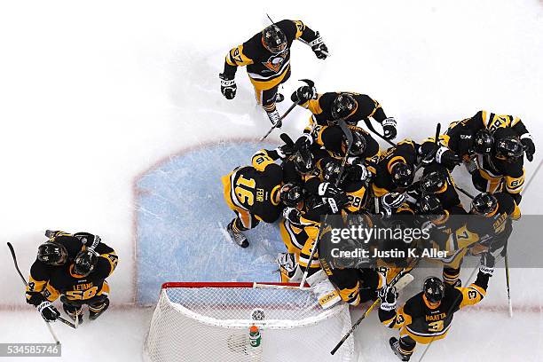 The Pittsburgh Penguins celebrate after defeating the Tampa Bay Lightning in Game Seven of the Eastern Conference Final with a score of 2 to 1 during...