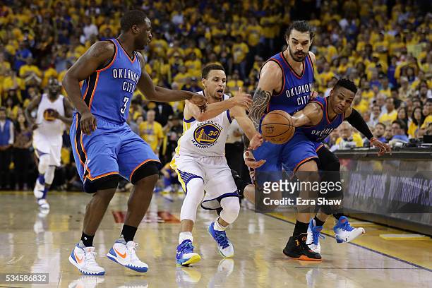 Stephen Curry of the Golden State Warriors reaches for a loose ball against Dion Waiters, Steven Adams and Russell Westbrook of the Oklahoma City...