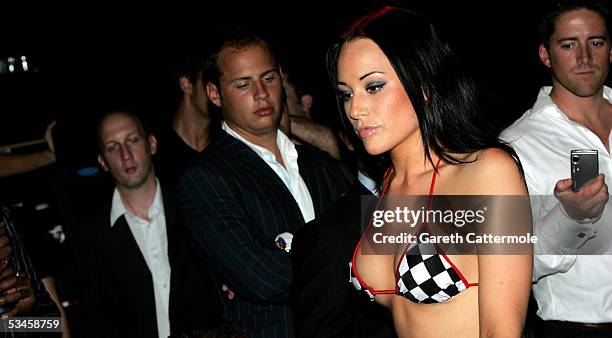 Men watch a model as she participates in the Gridmodels 2006 Calendar Catwalk Competition at The Penthouse on August 24, 2005 in London, England. The...