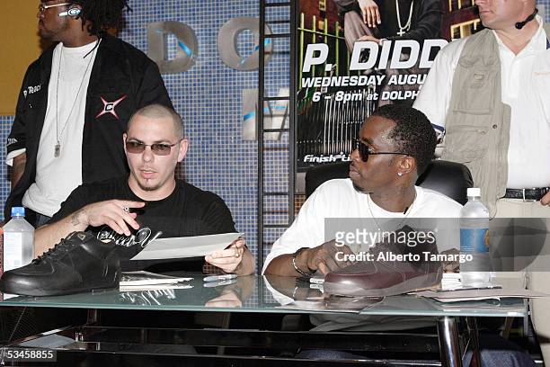 Sean "Diddy" Combs and Bad Boy Latino artist Pitbull attend the launch of Combs' footwear collection, Sean John Elite Footwear at the Dolphin Mall on...