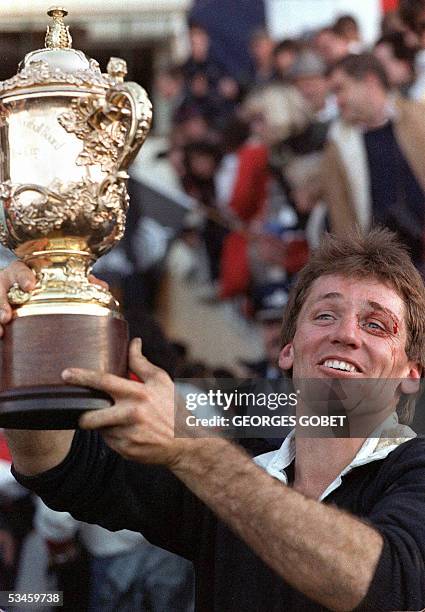 This file photo taken 20 June 1987 shows then-All Black captain David Kirk holding up the "William Webb Ellis" trophy after New Zealand's victory in...