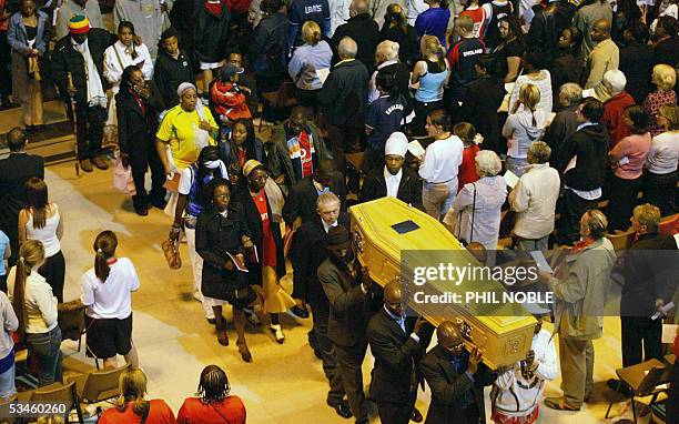 Liverpool, UNITED KINGDOM: The family of murdered teenager Anthony Walker follow his coffin as it is carried from Liverpool Cathedral following his...