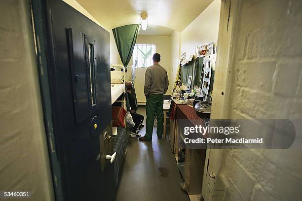 Prisoners look towards a window in a cell in A Wing of Norwich Prison on August 25, 2005 in Norwich, England. A Chief Inspector of Prisons report on...