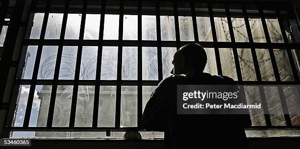 Year old inmate James looks out of the window of the Young Offenders Institution attached to Norwich Prison on August 25, 2005 in Norwich, England. A...