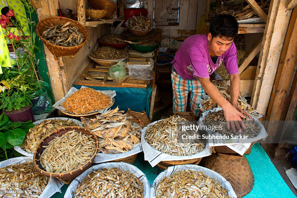 A man sells dried fish at Iewduh Bazar in Shillong,...