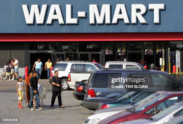 Clinton, UNITED STATES: Customers leave a Wal-Mart store in Clinton, Maryland, 23 August, 2005. The first Wal-Mart was opened in 1962 in Rogers,...