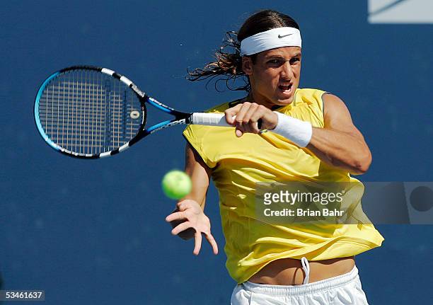 Feliciano Lopez of Spain follows through on a backhand against Vincent Spadea during the Pilot Pen Tennis tournament on August 25, 2005 at the...