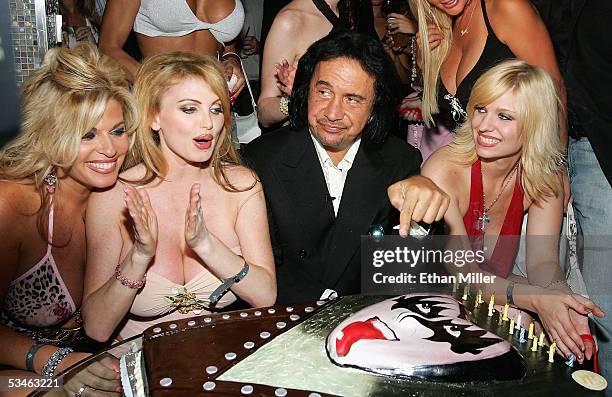 Kiss singer/bassist Gene Simmons points to his birthday cake during his birthday party at the Ghostbar at the Palms Casino Resort August 25, 2005 in...