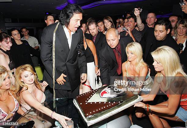 Kiss singer/bassist Gene Simmons reacts as his birthday cake arrives during his birthday party at the Ghostbar at the Palms Casino Resort August 25,...