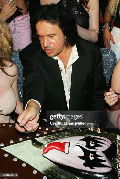 Kiss singer/bassist Gene Simmons examines the tongue on his birthday cake during his birthday party at the Ghostbar at the Palms Casino Resort August...