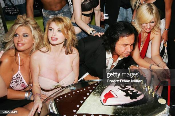 Kiss singer/bassist Gene Simmons blows out the candles on his birthday cake during his birthday party at the Ghostbar at the Palms Casino Resort...