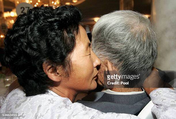 South Korean Kim Jung-Jin ,95 years old listen from his North Korean wife at the Kumgangsan hotel on August 26, 2005 in Mt. Kumgang, North Korea. On...