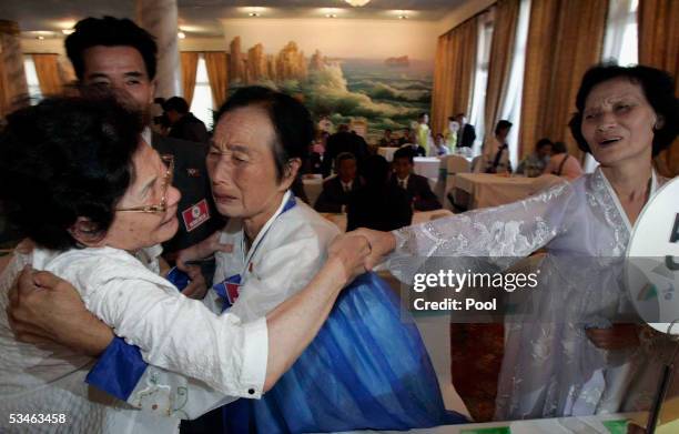 South Korean Yoo Mu-Un ,80 years old cries as she meets her North Korean sisters at the Kumgangsan hotel on August 26, 2005 in Mt. Kumgang, North...