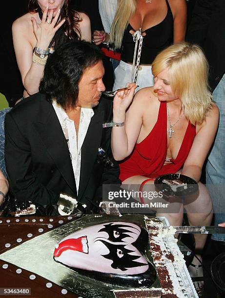 Kiss singer/bassist Gene Simmons is fed some of his birthday cake from a friend Kristy Fuchs during his birthday party at the Palms Casino Resort...