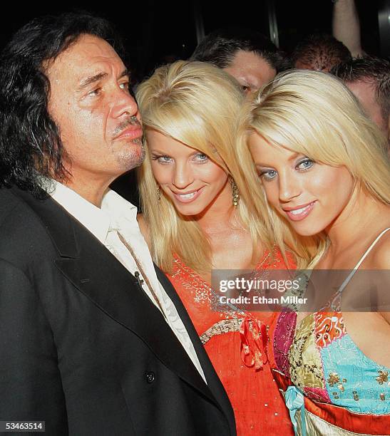 Kiss singer/bassist Gene Simmons poses with "Palms Girls" models, twin sisters Ruth Quinn and Ryan Wahrenbrock during his birthday party at the Palms...