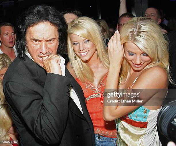 Kiss singer/bassist Gene Simmons poses with "Palms Girls" models, twin sisters Ruth Quinn and Ryan Wahrenbrock during his birthday party at the Palms...