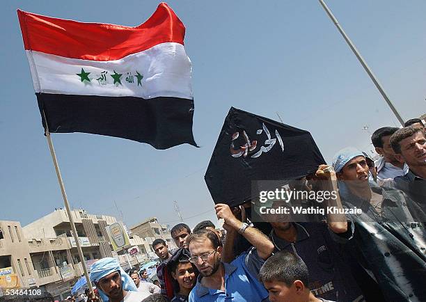 Iraqi supporters of radical Shiite cleric Moqtada al-Sadr carry a coffin which reads "Services" as they demonstrate against the poor performance of...