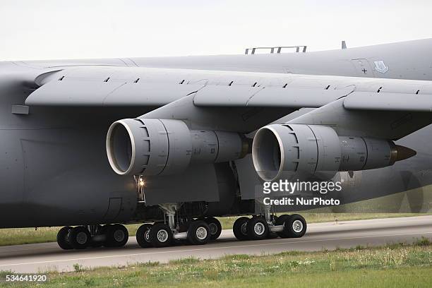 Giant military cargo aircraft Lockheed C-5 Galaxy takes off Gdansk Lech Walesa airport, on May 26, 2016. Group of US Soldiers with 7 vehicles Humvee...