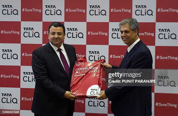 Tata Sons Chairman Cyrus Mistry receives the first delivery packet from Chairman of Trent Ltd and Managing Director of Tata International Noel Tata...