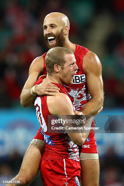Jarrad McVeigh of the Swans celebrates kicking a goal with team mate Zak Jones during the round 10 AFL match between the Sydney Swans and the North...