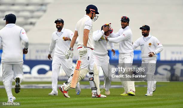 The Sri Lanka fielders celebrate as England batsman Alastair Cook leaves the wickets after being dismissed during day one of the 2nd Investec Test...