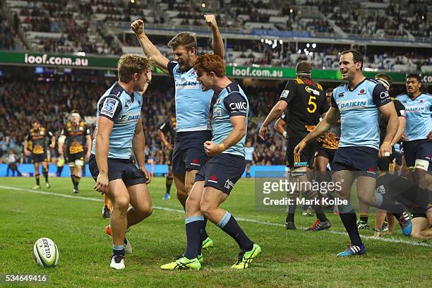 Michael Hooper of the Waratahs celebrates with his team mates Rob Horne, Andrew Kellaway and Matt Carraro of the Waratahs after scoring a try during...