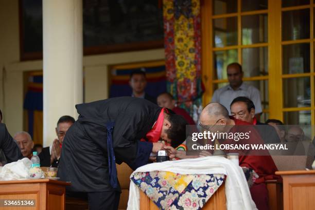 The re-elected Sikyong Lobsang Sangay is blessed by Tibetan Spiritual leader the Dalai Lama during Sangay's swearing-in ceremony at the Tsuglakhang...