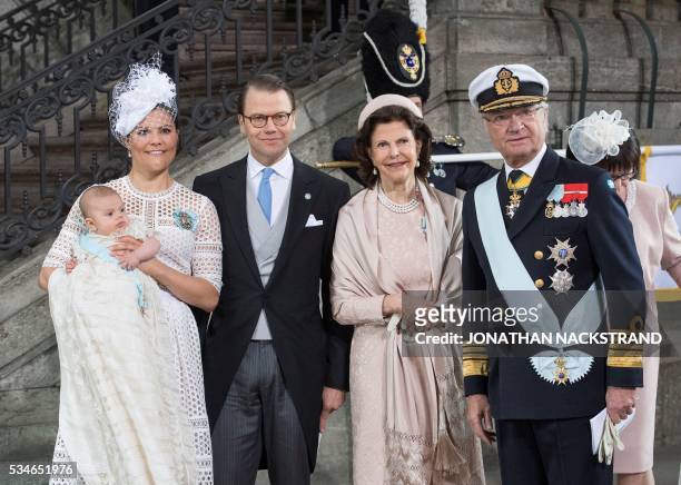 Crown Princess Victoria of Sweden holds her son Prince Oscar of Sweden next to Prince Daniel of Sweden, Queen Silvia of Sweden and King Carl XVI...