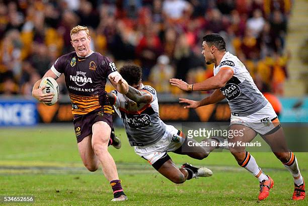Jack Reed of the Broncos attempts to break away from the defence during the round 12 NRL match between the Brisbane Broncos and the Wests Tigers at...