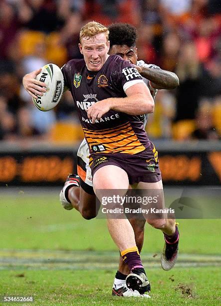 Jack Reed of the Broncos attempts to break away from the defence during the round 12 NRL match between the Brisbane Broncos and the Wests Tigers at...