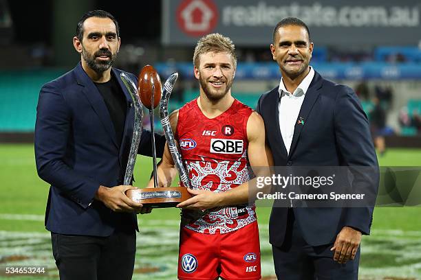 Kieren Jack of the Swans poses with Adam Goodes and Michael O'Loughlin with the Marn Grook Trophy after winning the round 10 AFL match between the...