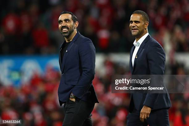 Former Swans players, Adam Goodes and Michael O'Loughlin enter the field to present the Marn Grook Trophy after the round 10 AFL match between the...