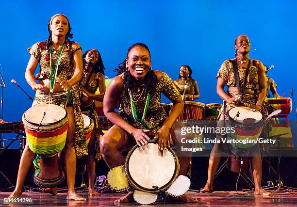 Members of Nimbaya! the Women's Drum and Dance Company of Guinea plays djembe drums as they perform during the group's New York City debut in a World...