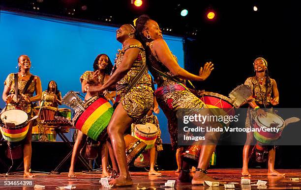 Members of Nimbaya! the Women's Drum and Dance Company of Guinea plays djembe drums as they perform during the group's New York City debut in a World...
