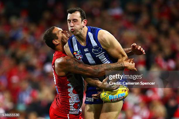 Todd Goldstein of the Kangaroos is tackled by Lance Franklin of the Swans during the round 10 AFL match between the Sydney Swans and the North...