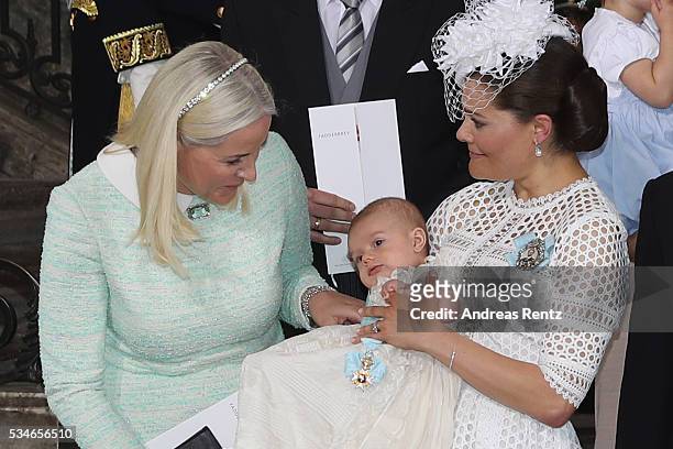 Crown Princess Mette-Marit of Norway, Crown Princess Victoria of Sweden and Prince Oscar of Sweden are seen after the christening of Prince Oscar of...