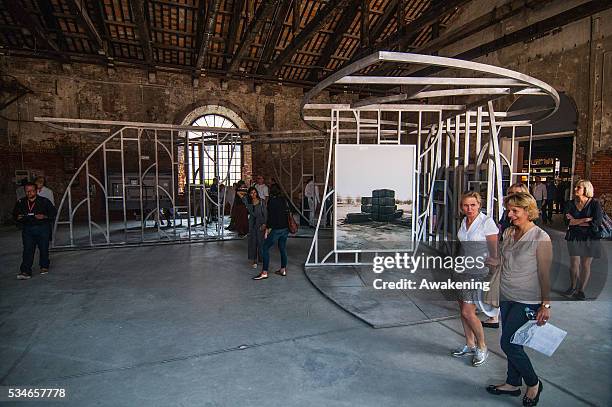 People attend Kingdom of Bahrain Pavilion of the 15th Architecture Venice Biennale, on May 27, 2016 in Venice, Italy. The 15th International...