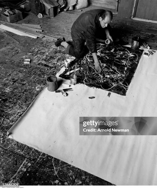 Abstract Expressionist painter Jackson Pollock at work in his Long Island studio January 3, 1949 in East Hampton, New York.