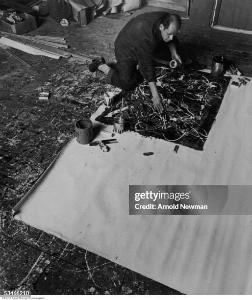 Abstract Expressionist painter Jackson Pollock at work in his Long Island studio January 3, 1949 in East Hampton, New York.