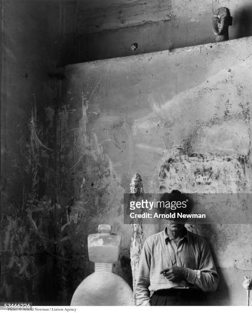 Swiss sculptor Alberto Giacometti poses for portrait in his studio May 12, 1954 in Paris France.