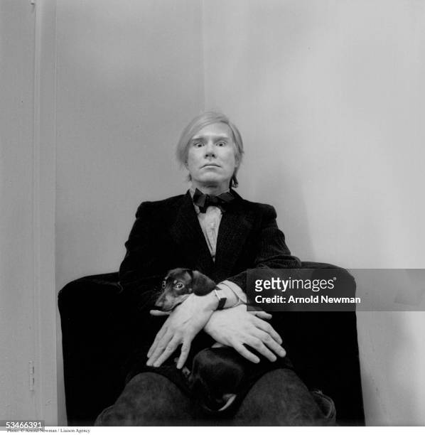Portrait of Andy Warhol, American Pop artist, with his dog at his studio February 2, 1973 in New York City.