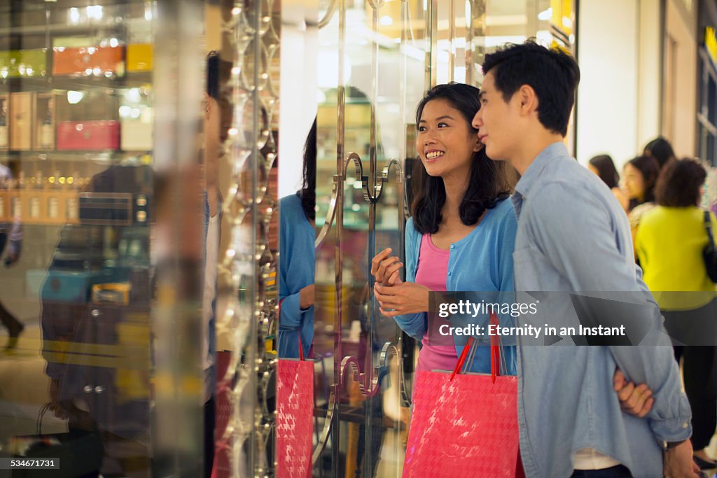 Couple shopping together in a shopping mall.