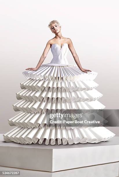 young woman in large white paper craft dress - haute couture stock-fotos und bilder