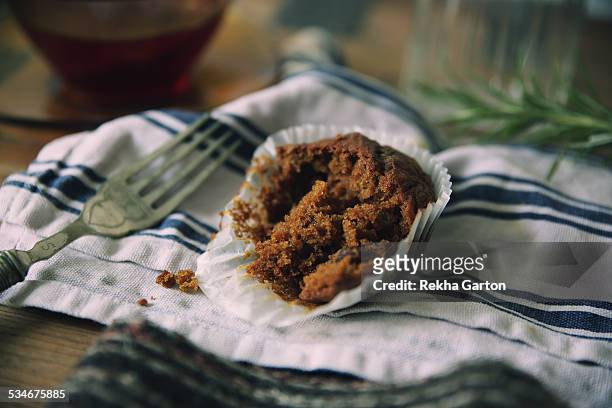 half eaten cupcake - rekha garton stock-fotos und bilder