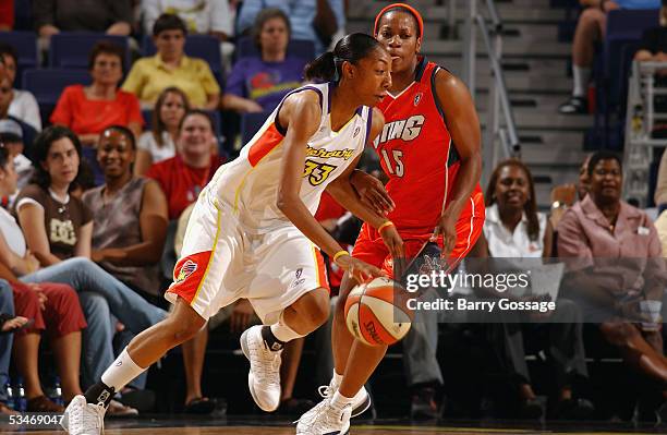 Angelina Williams of the Phoenix Mercury drives around Jia Perkins of the Charlotte Sting during a WNBA game at America West Arena on July 13, 2005...