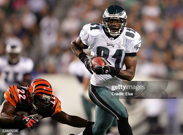 Wide receiver Terrell Owens of the Philadelphia Eagles runs past safety Kim Herring of the Cincinnati Bengals during the first half of their...